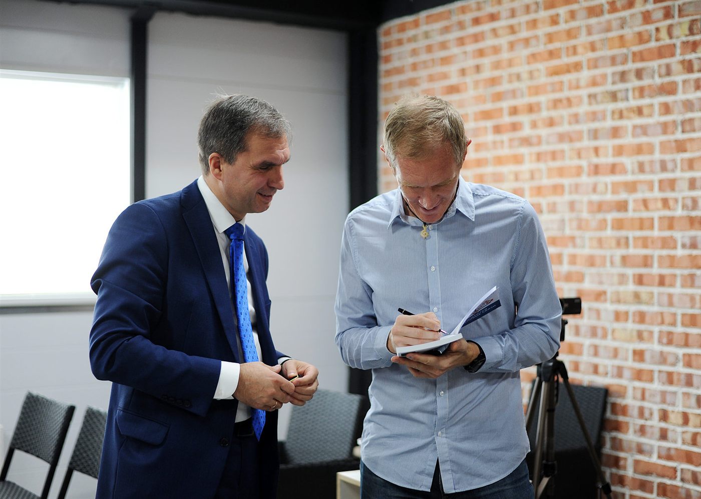 Signing a book at a workshop